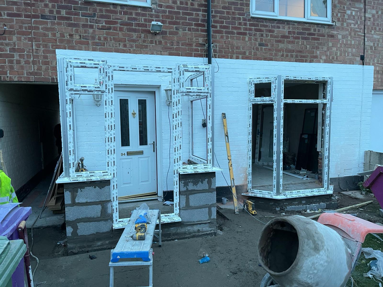 A porch build under way — tiled roof on and windows fitted