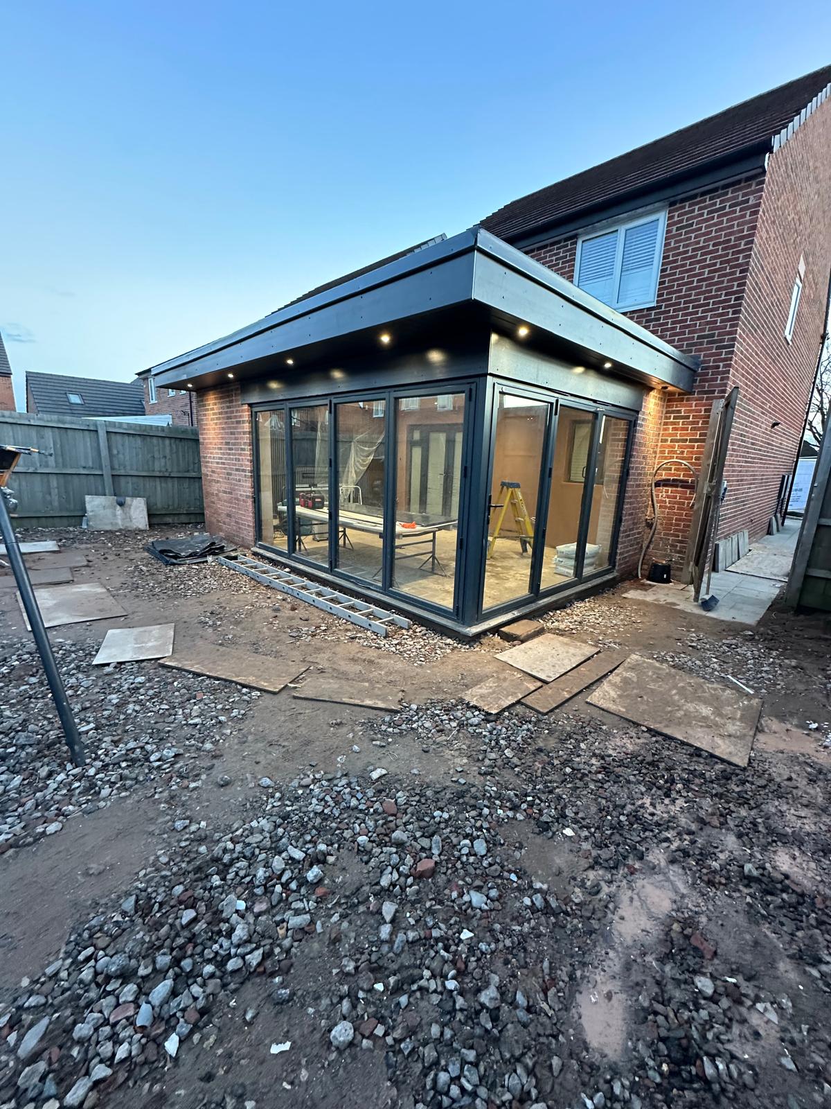 A new extension with bi-fold doors and downlights, photographed at dusk